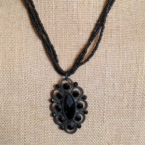 NY three strand black bead with pendant necklace